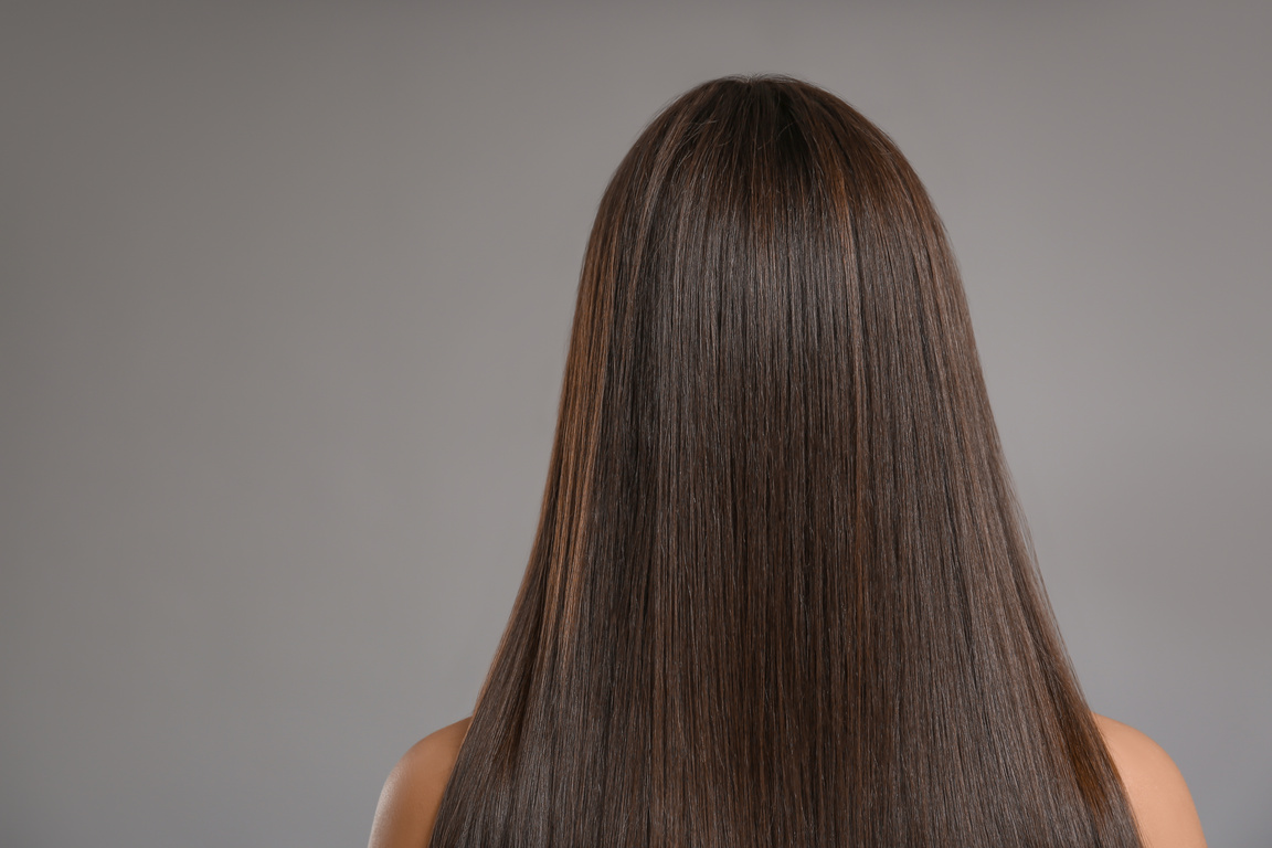 Woman with Beautiful Straight Hair on Grey Background
